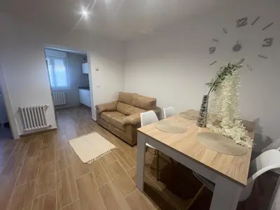 a living room with a table and a couch at El pisito de Cris y Mia in Ponferrada