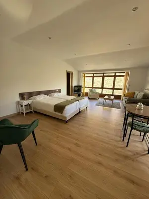 a large bedroom with a bed and a table and chairs at A Casa do Veterinario in Sales