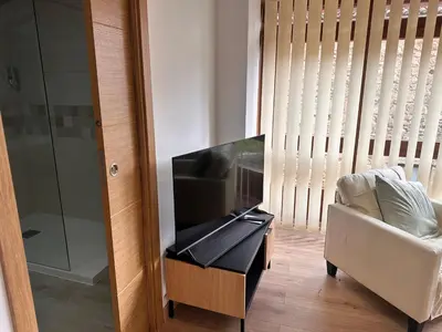 a living room with a flat screen tv and a couch at A Casa do Veterinario in Sales