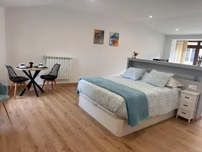a bedroom with a bed and a table with chairs at A Casa do Veterinario in Sales