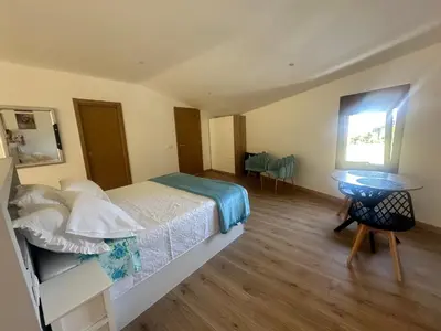 a bedroom with a bed and a table and a window at A Casa do Veterinario in Sales