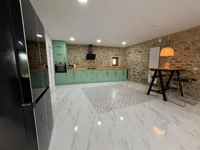 a kitchen with green cabinets and a table in it at A Casa do Veterinario in Sales