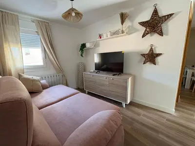 a living room with a couch and a tv and stars on the wall at El pisito de la Estrella in Ponferrada