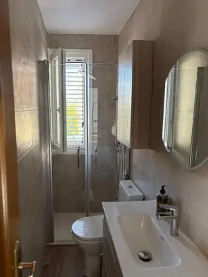 a bathroom with a toilet and a sink and a shower at El pisito de la Estrella in Ponferrada