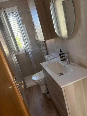 a bathroom with a sink and a toilet and a mirror at El pisito de la Estrella in Ponferrada