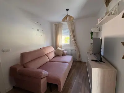 a living room with a couch and a television at El pisito de la Estrella in Ponferrada