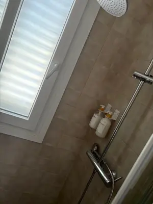 a bathroom with a shower with a window at El pisito de la Estrella in Ponferrada