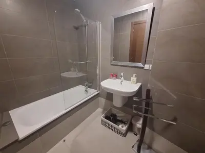a bathroom with a sink and a shower and a tub at Apartamento Centro Calle Reina in Lugo
