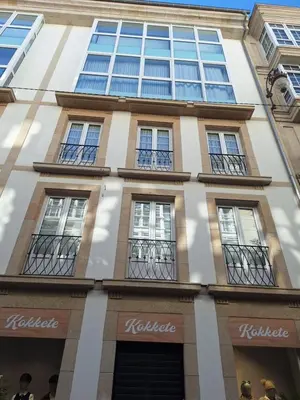 a facade of a building with windows at Apartamento Centro Calle Reina in Lugo