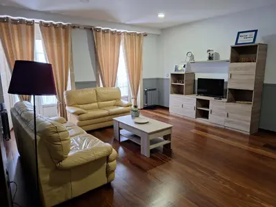 a living room with a couch and a table at Apartamento Centro Calle Reina in Lugo