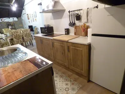 a kitchen with a white refrigerator and a sink at Luna Creciente Casa Luna de La Viliella in La Viliella