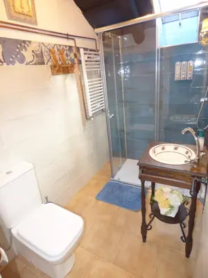 a bathroom with a toilet and a sink and a shower at Luna Creciente Casa Luna de La Viliella in La Viliella