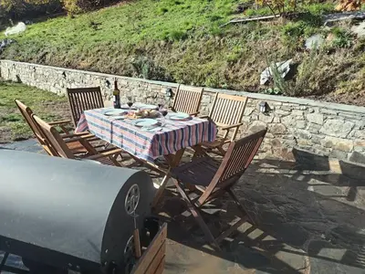 a table and chairs with a dog sitting on top of it at Luna Creciente Casa Luna de La Viliella in La Viliella