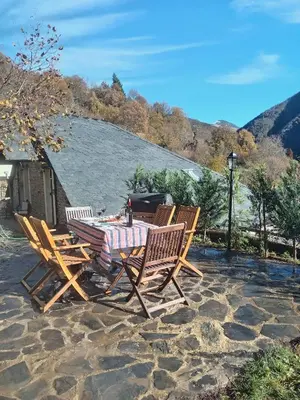 a table and chairs sitting on a patio at Luna Creciente Casa Luna de La Viliella in La Viliella