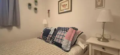 a bedroom with a bed with pillows on it at Manzaneda Natura T1 in Puebla de Trives