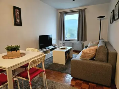 a living room with a couch and a table at Manzaneda Natura T1 in Puebla de Trives