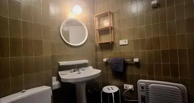 a bathroom with a sink and a mirror at Manzaneda Natura T1 in Puebla de Trives