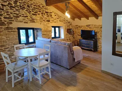 a living room with a table and a couch at Casa Veracruz Sanabria in Puebla de Sanabria