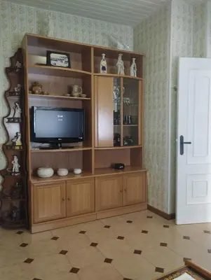 a television in a wooden entertainment center in a room at Casa Belén in Burela de Cabo