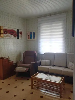 a living room with a couch and a coffee table at Casa Belén in Burela de Cabo