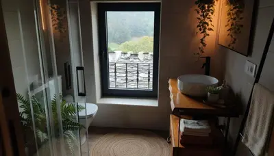 a bathroom with a sink and a window at La casa de las ovejas