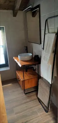 a bathroom with a sink and a mirror at La casa de las ovejas