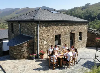 a group of people sitting around a table on a patio at La casa de las ovejas