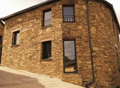 a brick building with windows on the side of it at La casa de las ovejas