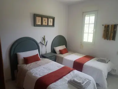 a room with two beds and a window at Casa do Pina in Villarmayor