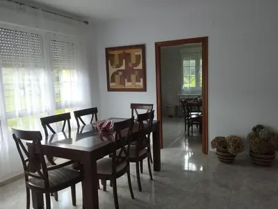 a dining room with a wooden table and chairs at Casa do Pina in Villarmayor