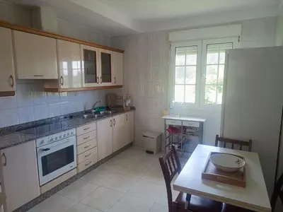 a kitchen with white cabinets and a table with a plate on it at Casa do Pina in Villarmayor