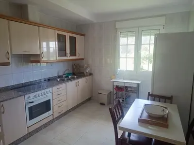a kitchen with white cabinets and a table with a plate on it at Casa do Pina in Villarmayor