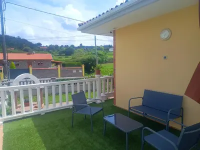 a balcony with chairs and a white fence at Casa do Pina in Villarmayor