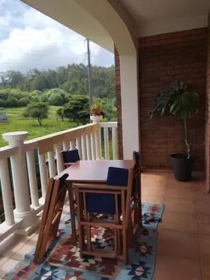 a porch with a table and chairs on a balcony at Casa do Pina in Villarmayor