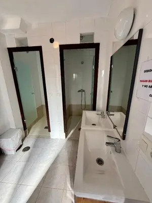 a bathroom with two sinks and two mirrors at Meson el Acebo in El Acebo de San Miguel