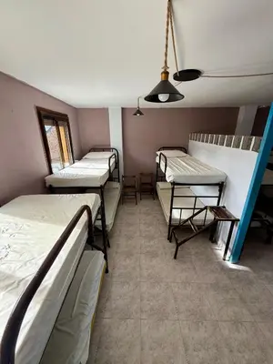 a room with three bunk beds in it at Meson el Acebo in El Acebo de San Miguel