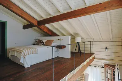 a bedroom with a bed and a wooden ceiling at Casa da Edrada