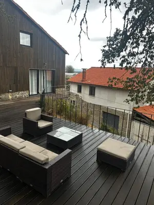 a deck with couches and tables on a building at Casa da Edrada