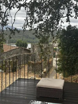 a bed sitting on top of a wooden deck at Casa da Edrada