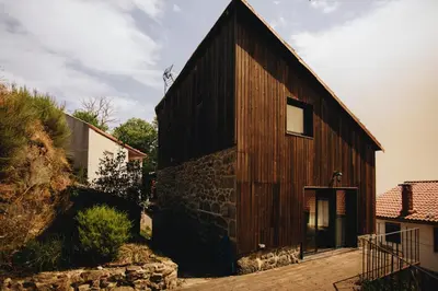 a large wooden building with a window on the side at Casa da Edrada