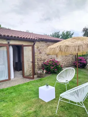 a pair of chairs and an umbrella in a yard at REMANSO DE TRASFONTAO 
