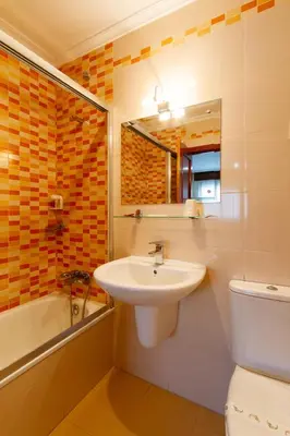 a bathroom with a sink and a toilet and a mirror at Motel Venecia in Taboadela