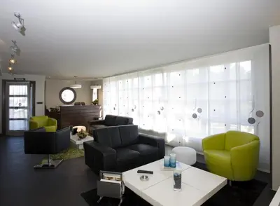 a living room with a couch and two chairs at Apartamentos Viavelez in La Caridad