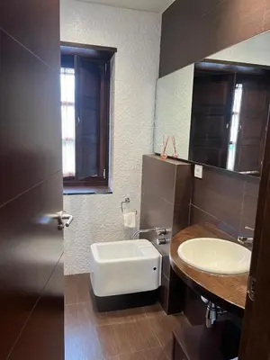a bathroom with a white sink and a mirror at Apartamentos Viavelez in La Caridad
