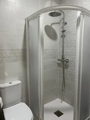a bathroom with a shower with a toilet at Pensión Ferreiriño in Quiroga