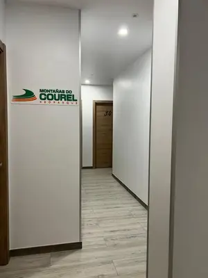 an office hallway with a sign on the wall at Pensión Ferreiriño in Quiroga