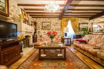 a living room with a couch and a table at Pazo do Vilar in Padrón