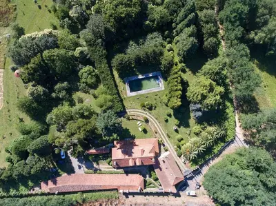 an overhead view of a house with a road and trees at Pazo do Vilar in Padrón