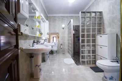 a bathroom with two sinks and two toilets at Pazo do Vilar in Padrón