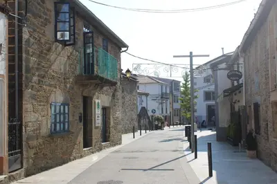 an empty street in an old town with buildings at Pensión CasaBlanca in Arzúa